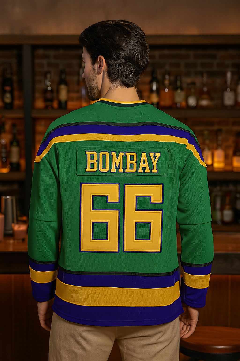 Person wearing a green sports jersey with 'Bombay' and number '66' in a bar setting